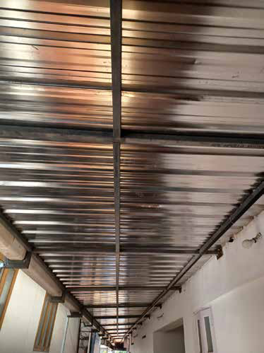 Stainless steel roofing sheets viewed from inside an industrial facility